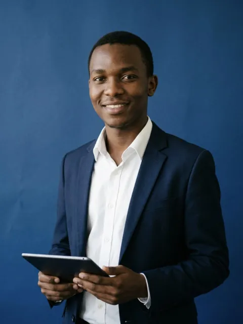 Business student in a blazer holding a tablet