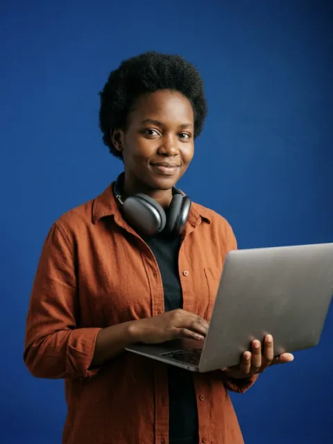 Computer science student holding a laptop