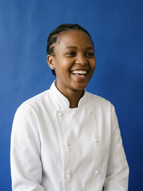 Hospitality student in a chef jacket